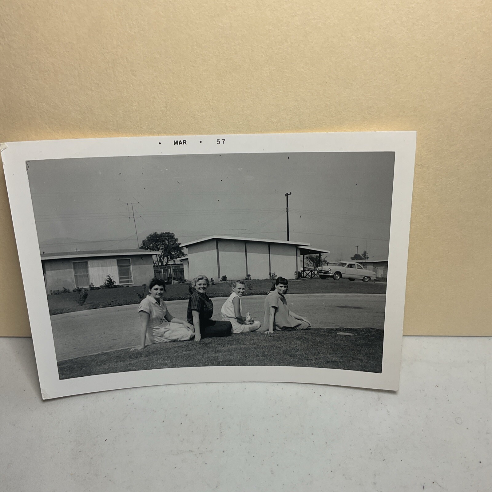 Mar 1957 Photograph 4 Women Sitting On Curb Lined Up Smiling Funny Weird B15A