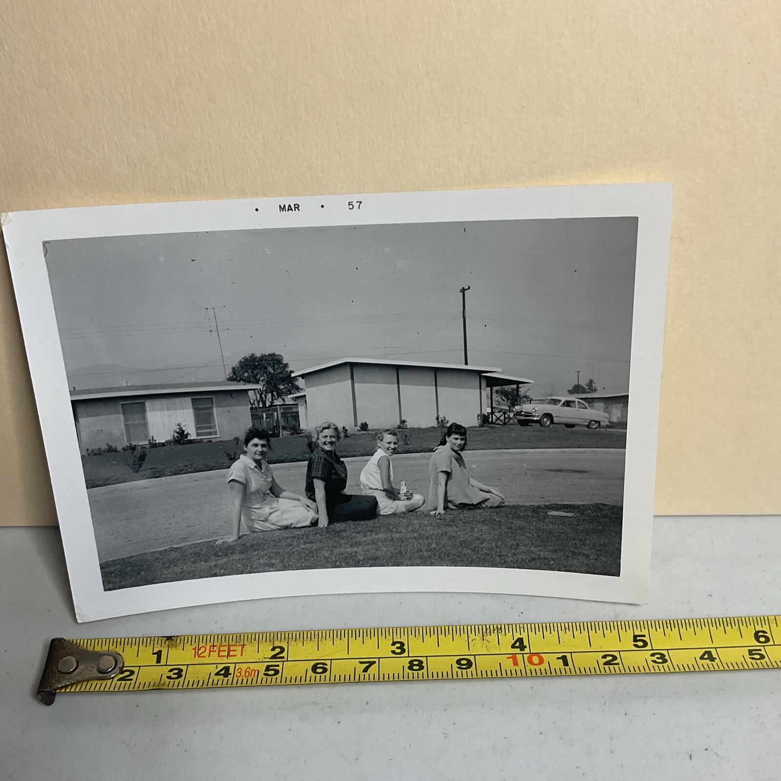 Mar 1957 Photograph 4 Women Sitting On Curb Lined Up Smiling Funny Weird B15A